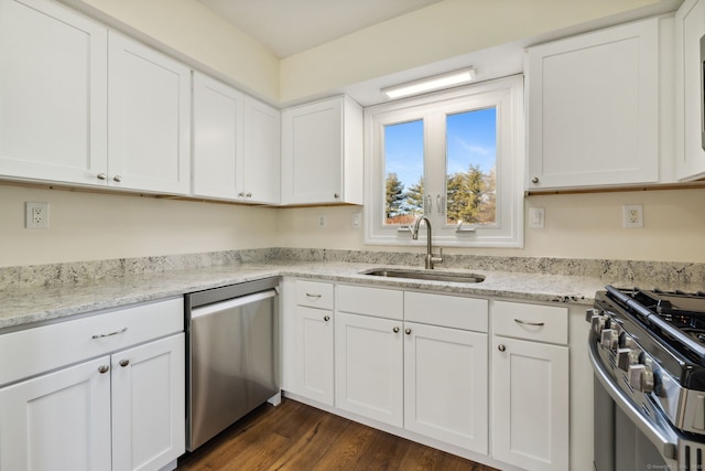 kitchen featuring appliances with stainless steel finishes, sink, and white cabinets