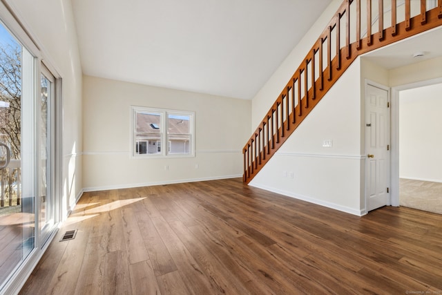 unfurnished living room featuring dark hardwood / wood-style floors