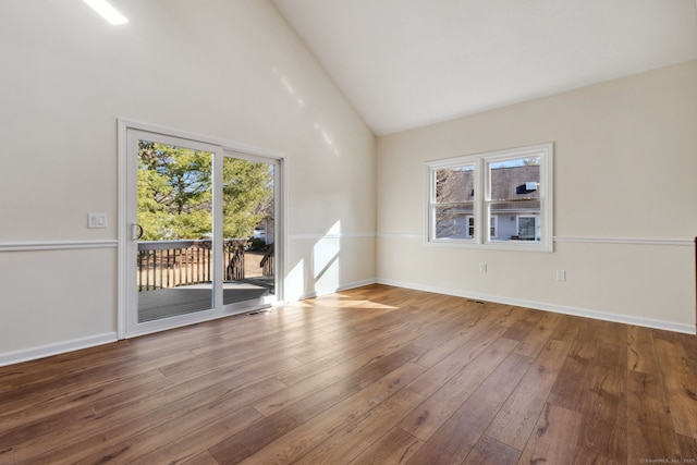 unfurnished room featuring hardwood / wood-style floors and high vaulted ceiling