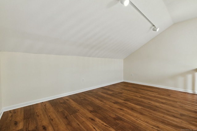 bonus room with lofted ceiling and dark hardwood / wood-style floors