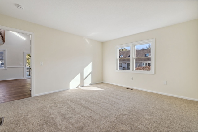 spare room featuring light colored carpet