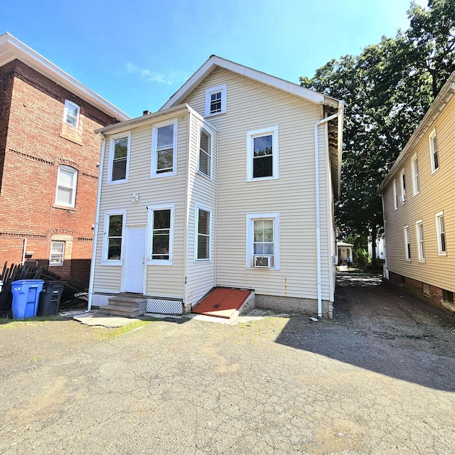 rear view of property with cooling unit