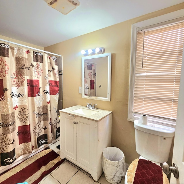 bathroom featuring tile patterned flooring, vanity, toilet, and a shower with shower curtain