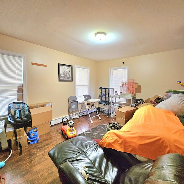 bedroom with wood-type flooring and baseboard heating