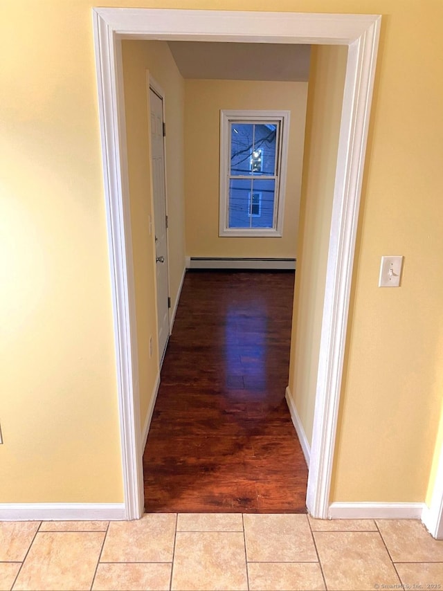 hallway featuring light tile patterned flooring and a baseboard radiator