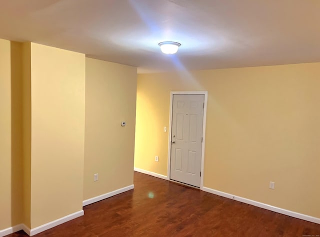 unfurnished room featuring dark wood-type flooring