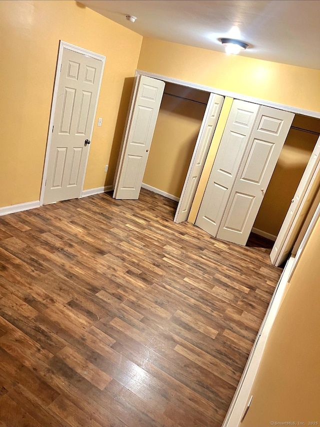 unfurnished bedroom featuring dark wood-type flooring