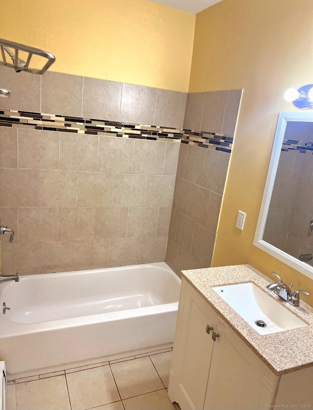 bathroom with tile patterned flooring, vanity, and tiled shower / bath combo