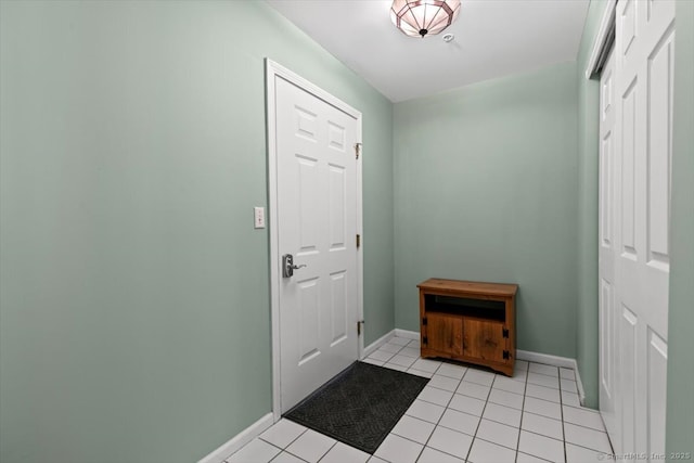 doorway to outside with light tile patterned flooring