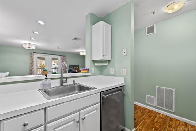 kitchen featuring dishwasher, white cabinetry, sink, dark wood-type flooring, and french doors