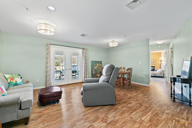 living room featuring french doors and wood-type flooring