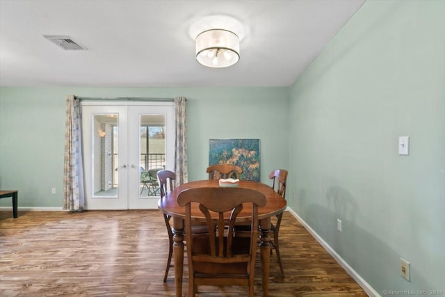 dining room with french doors and hardwood / wood-style floors