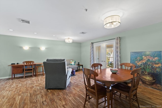 dining space featuring wood-type flooring