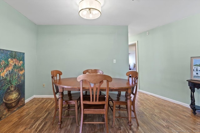 dining space with hardwood / wood-style flooring