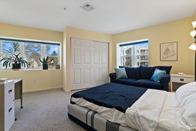 carpeted bedroom with a closet