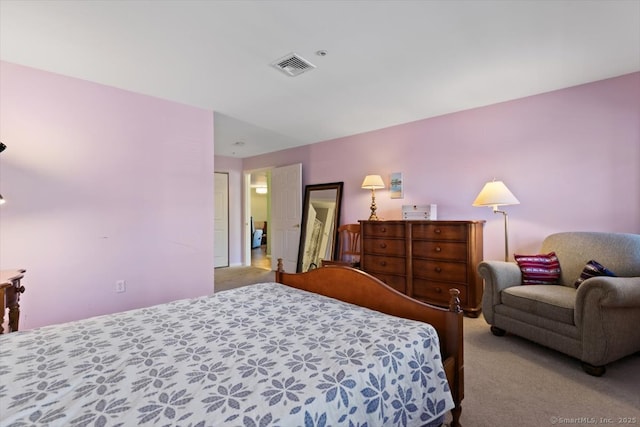 bedroom featuring light carpet