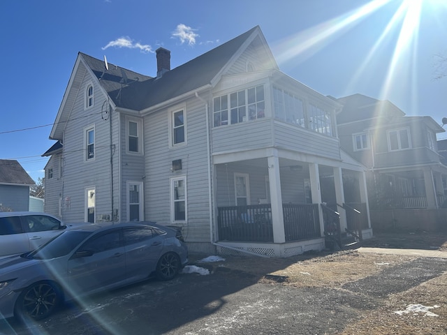 view of side of property with covered porch