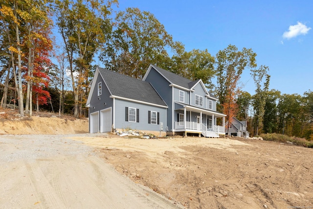 front of property with a porch and a garage