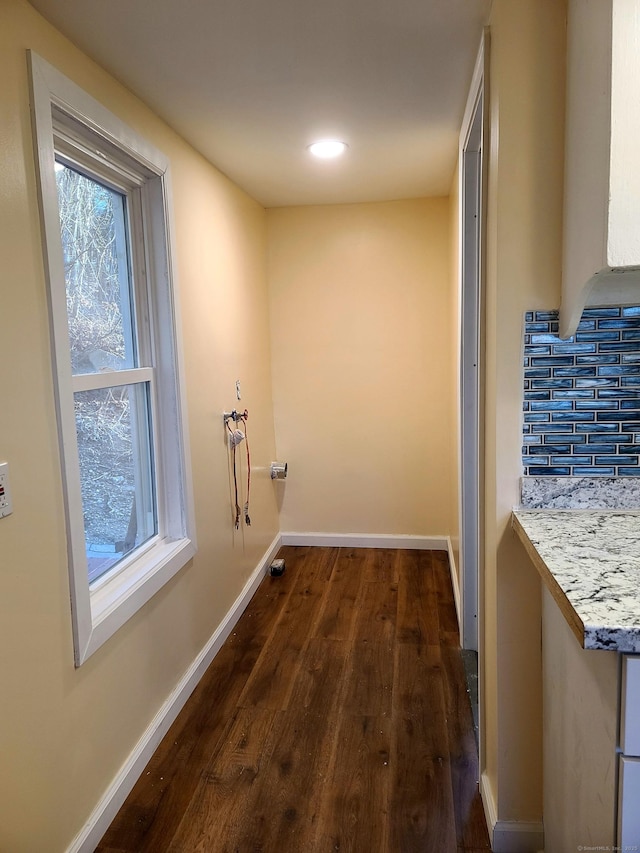 hall with recessed lighting, dark wood-style flooring, and baseboards