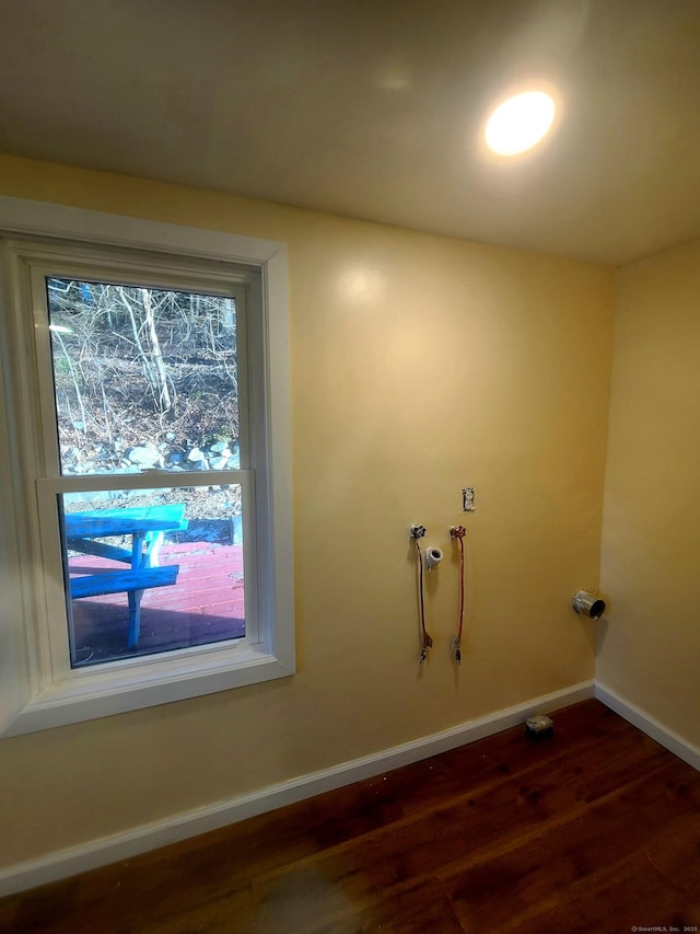 clothes washing area with washer hookup, laundry area, dark wood finished floors, and baseboards