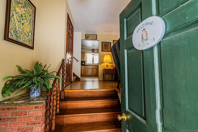 stairs with sink and hardwood / wood-style floors