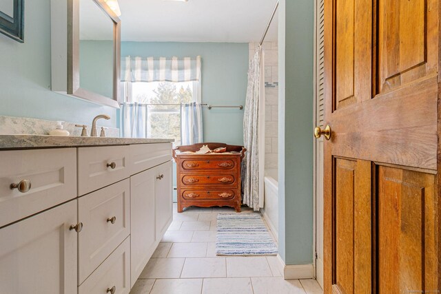 bathroom featuring vanity, tile patterned flooring, and shower / bath combo with shower curtain