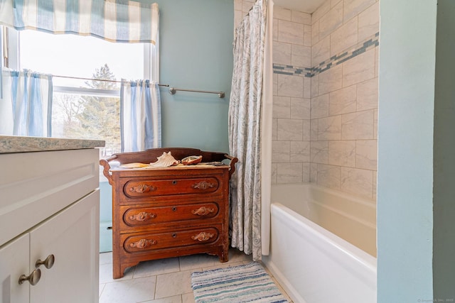 bathroom with tile patterned flooring, vanity, and shower / tub combo