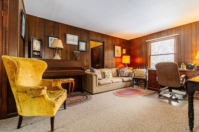 carpeted home office featuring wood walls