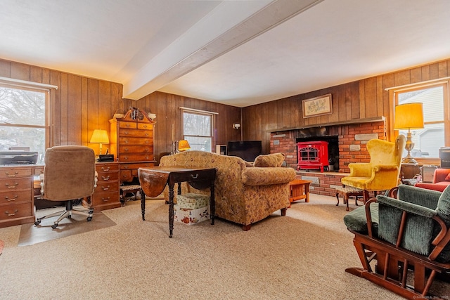 living room with plenty of natural light, light colored carpet, and beam ceiling