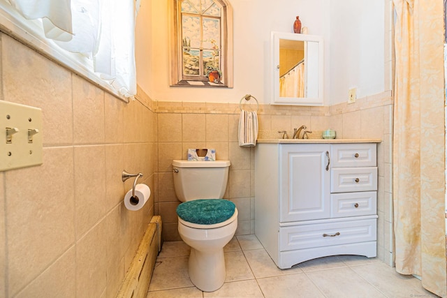 bathroom with tile patterned flooring, vanity, tile walls, and toilet