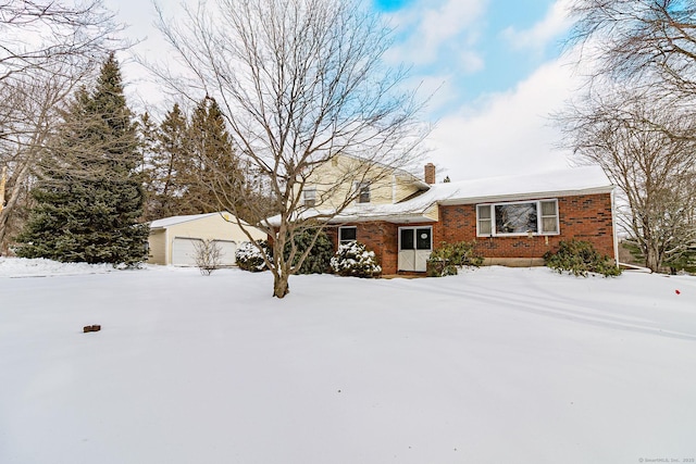 view of front of property featuring a garage and an outbuilding