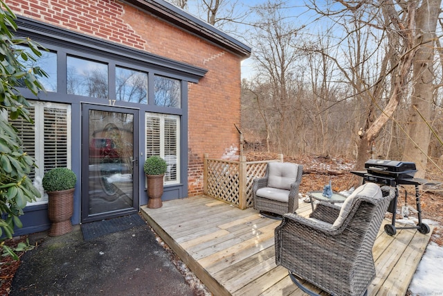 wooden terrace with a grill