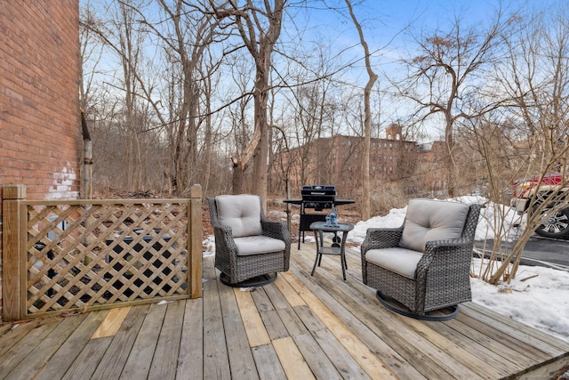 snow covered deck featuring a grill