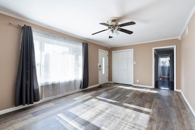 entrance foyer featuring ornamental molding, dark hardwood / wood-style floors, and ceiling fan