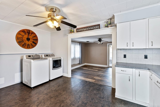 washroom featuring dark wood-type flooring, ceiling fan, cabinets, ornamental molding, and washer and dryer