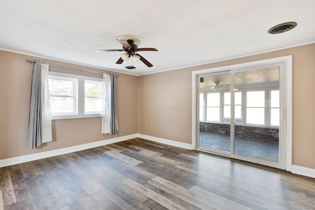 empty room with ceiling fan, ornamental molding, and dark hardwood / wood-style floors