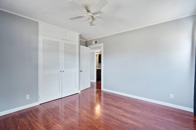 unfurnished bedroom with hardwood / wood-style floors, crown molding, a closet, and ceiling fan