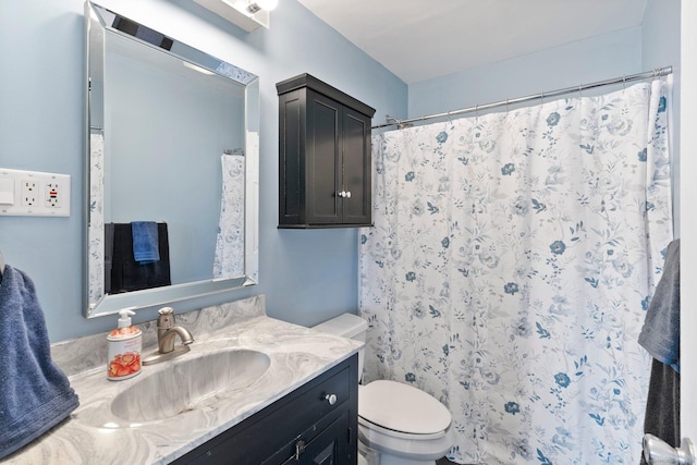 bathroom featuring vanity, toilet, and curtained shower