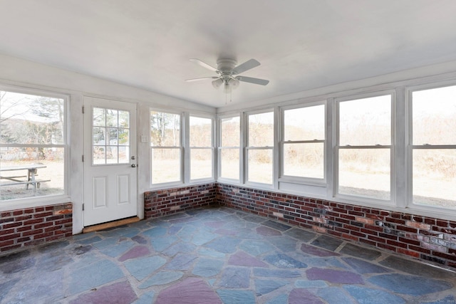 unfurnished sunroom with ceiling fan