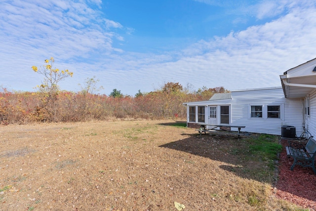 view of yard with a sunroom and cooling unit