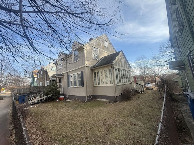 view of home's exterior with a yard