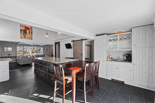 dining area featuring a barn door