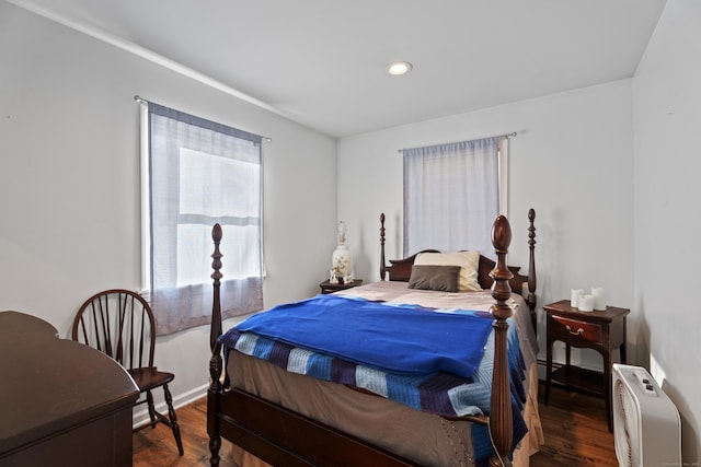 bedroom with dark wood-type flooring