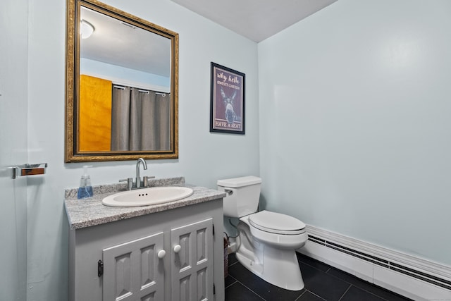 bathroom with tile patterned flooring, a baseboard radiator, vanity, and toilet