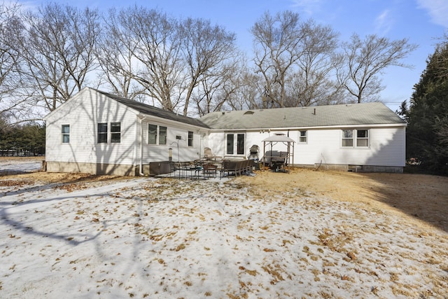 snow covered house featuring a gazebo