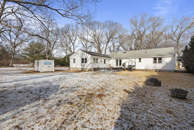 snow covered property featuring an outdoor fire pit