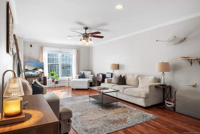 living room with ceiling fan, ornamental molding, and hardwood / wood-style floors