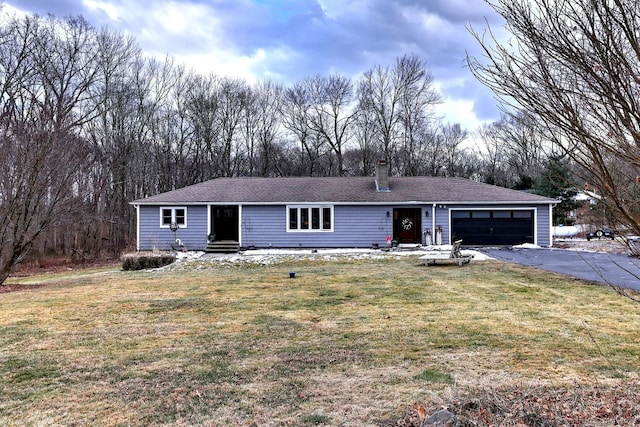 ranch-style home with a garage and a front yard