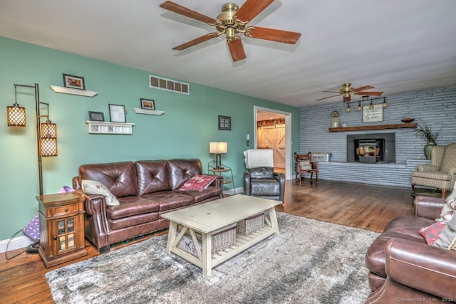 living room with dark wood-type flooring and ceiling fan