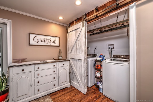 washroom featuring ornamental molding, a barn door, washer and dryer, and dark hardwood / wood-style flooring